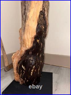 A Women Figure Make Completely Out Of Wood With Gold Foil And A Stained Surface