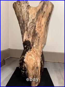 A Women Figure Make Completely Out Of Wood With Gold Foil And A Stained Surface