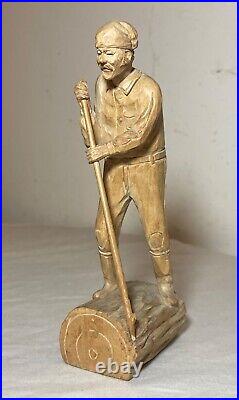 Antique hand carved wood Folk Art lumberjack man cutting wood sculpture statue