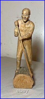 Antique hand carved wood Folk Art lumberjack man cutting wood sculpture statue