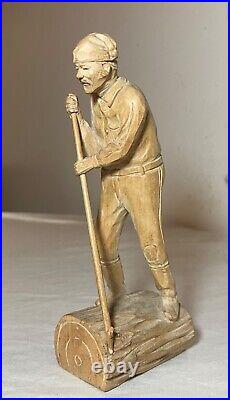 Antique hand carved wood Folk Art lumberjack man cutting wood sculpture statue