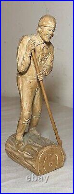 Antique hand carved wood Folk Art lumberjack man cutting wood sculpture statue