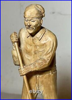 Antique hand carved wood Folk Art lumberjack man cutting wood sculpture statue