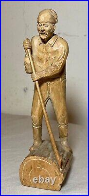 Antique hand carved wood Folk Art lumberjack man cutting wood sculpture statue