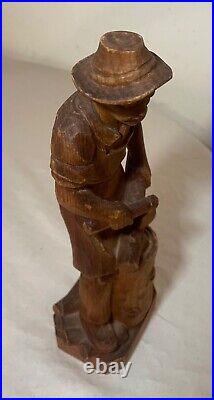 Antique hand carved wood Folk Art lumberjack man cutting wood sculpture statue