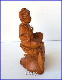 Hand-Carved Wooden Meditating Buddha Statue sitting on flower ontop of mount