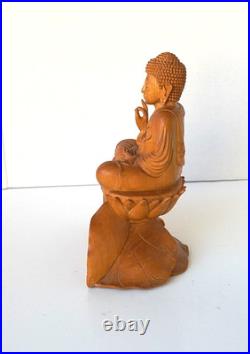 Hand-Carved Wooden Meditating Buddha Statue sitting on flower ontop of mount