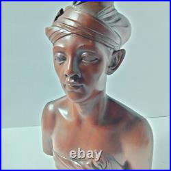 Hand-carved wooden bust of a Balinese man wearing traditional headdress'udeng