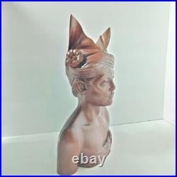 Hand-carved wooden bust of a Balinese man wearing traditional headdress'udeng