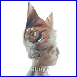 Hand-carved wooden bust of a Balinese man wearing traditional headdress'udeng