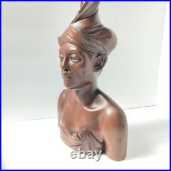 Hand-carved wooden bust of a Balinese man wearing traditional headdress'udeng