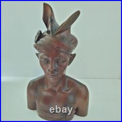 Hand-carved wooden bust of a Balinese man wearing traditional headdress'udeng