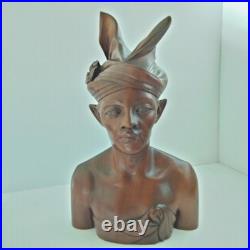 Hand-carved wooden bust of a Balinese man wearing traditional headdress'udeng
